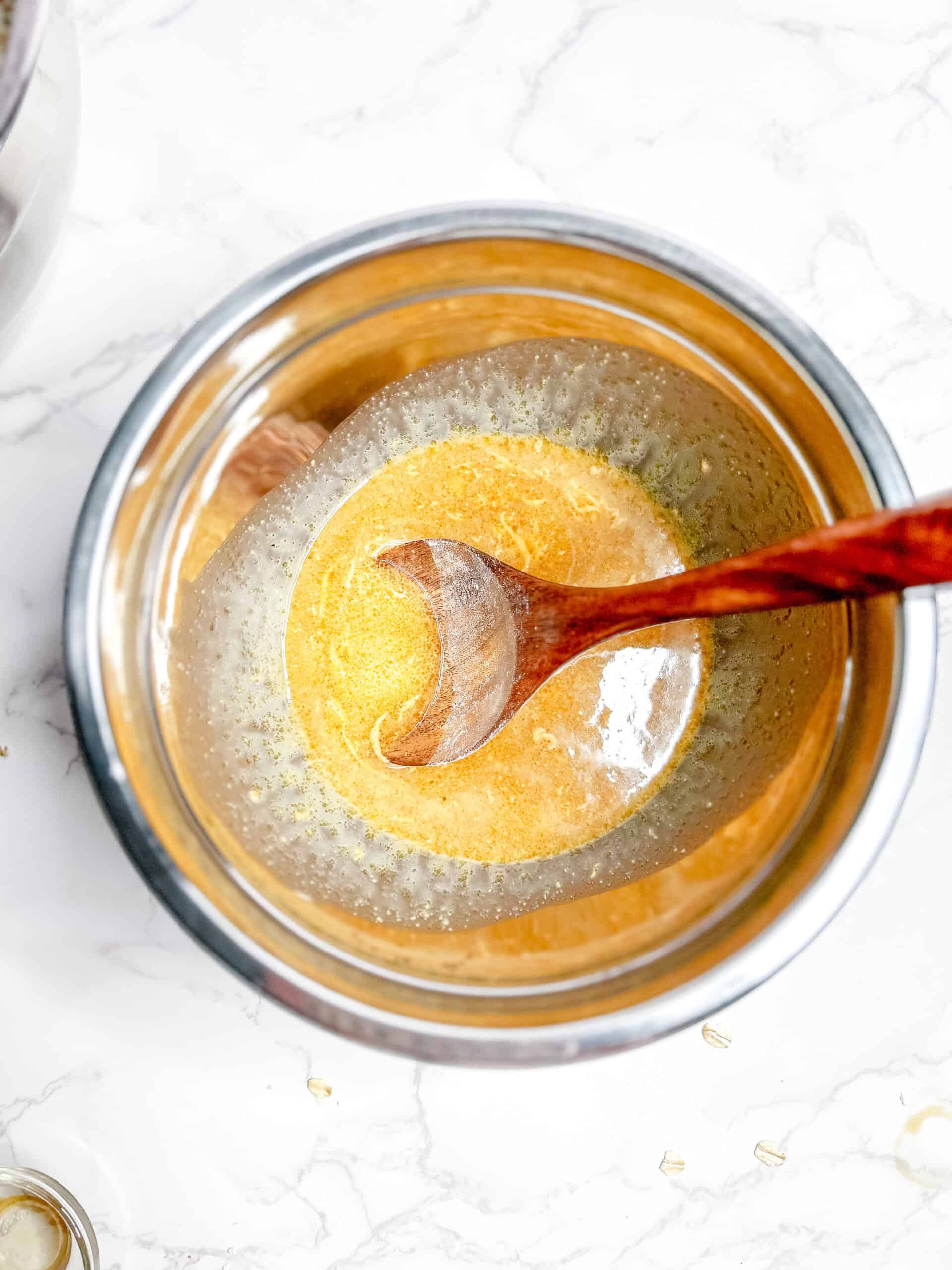 A mixing bowl with the wet ingredients 