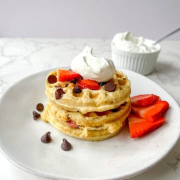 Fresh Milled flour waffles with chocolate chips and strawberries topped with homemade whip cream