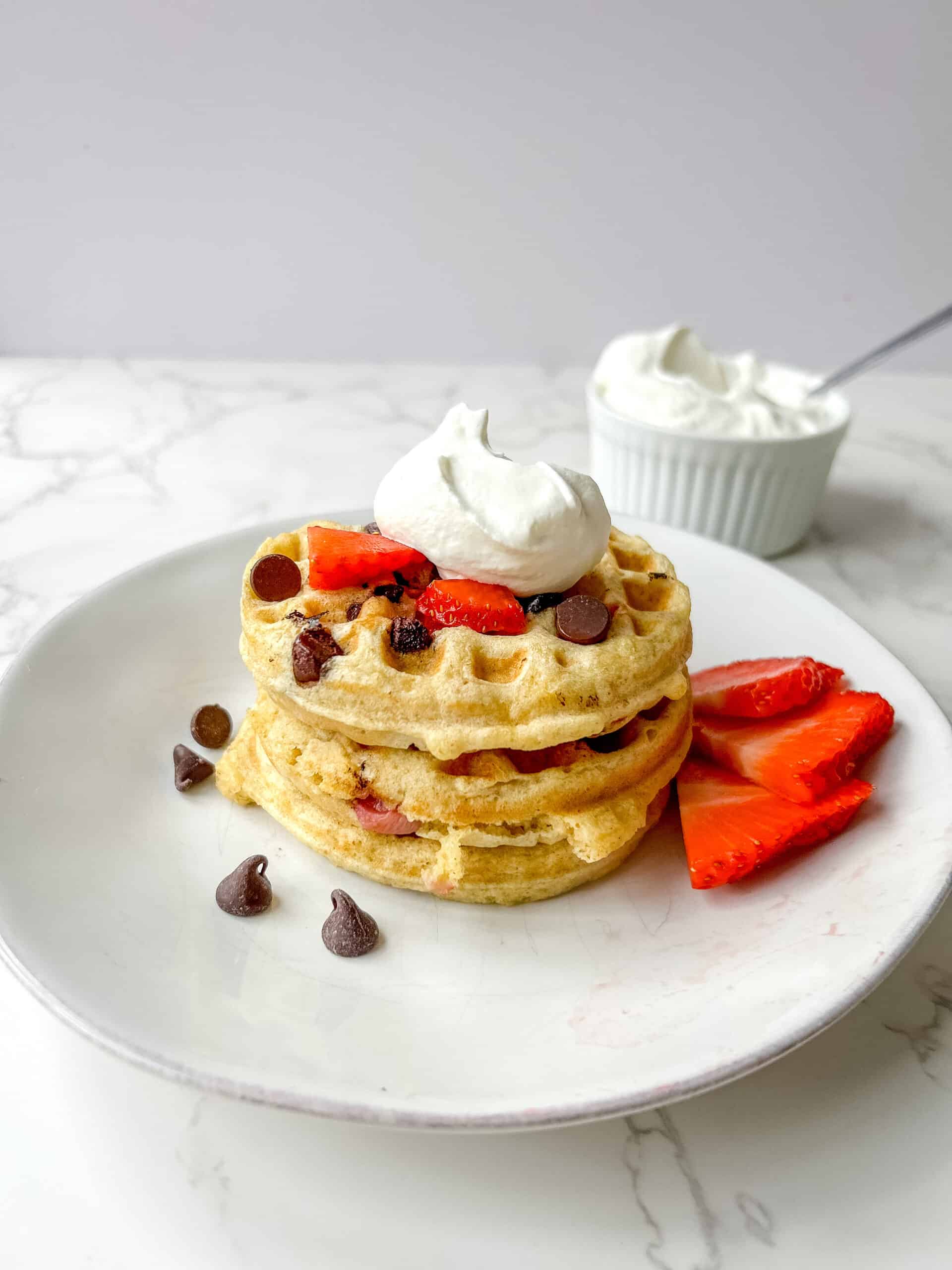 Fresh Milled flour waffles with chocolate chips and strawberries topped with homemade whip cream