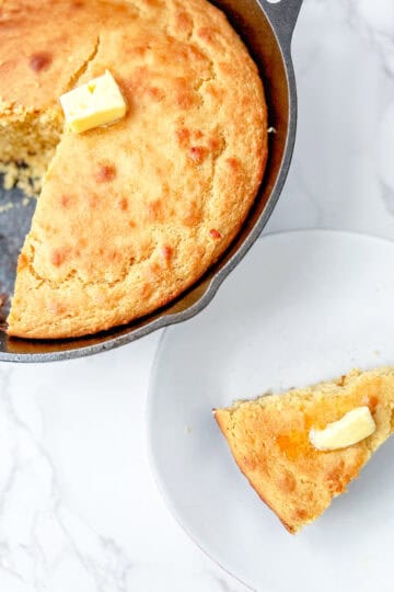 fresh milled flour cornbread sliced on a plate with butter